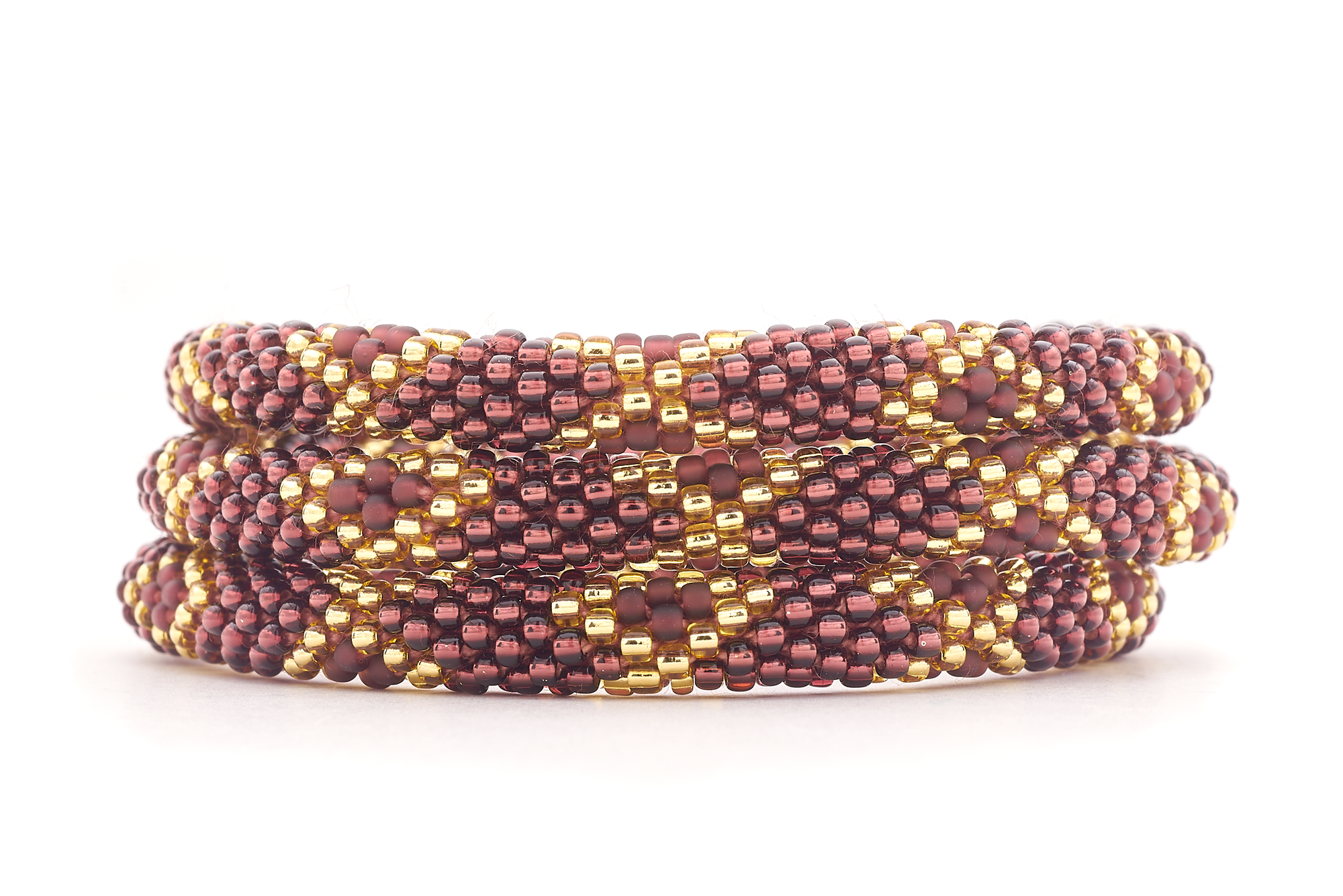 Sashka Co. handmade glass beaded friendship bracelet with gold and plum glass beads in a diamond pattern. Crafted in Nepal by skilled artisans.