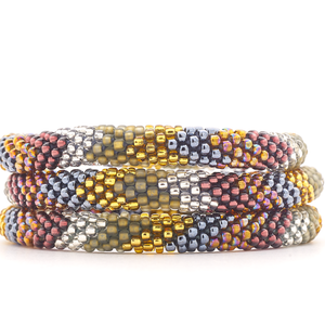 Sashka Co. handmade glass beaded friendship bracelet with gold, silver, plum, matte brown, and iridescent glass beads. Crafted in Nepal by skilled artisans.