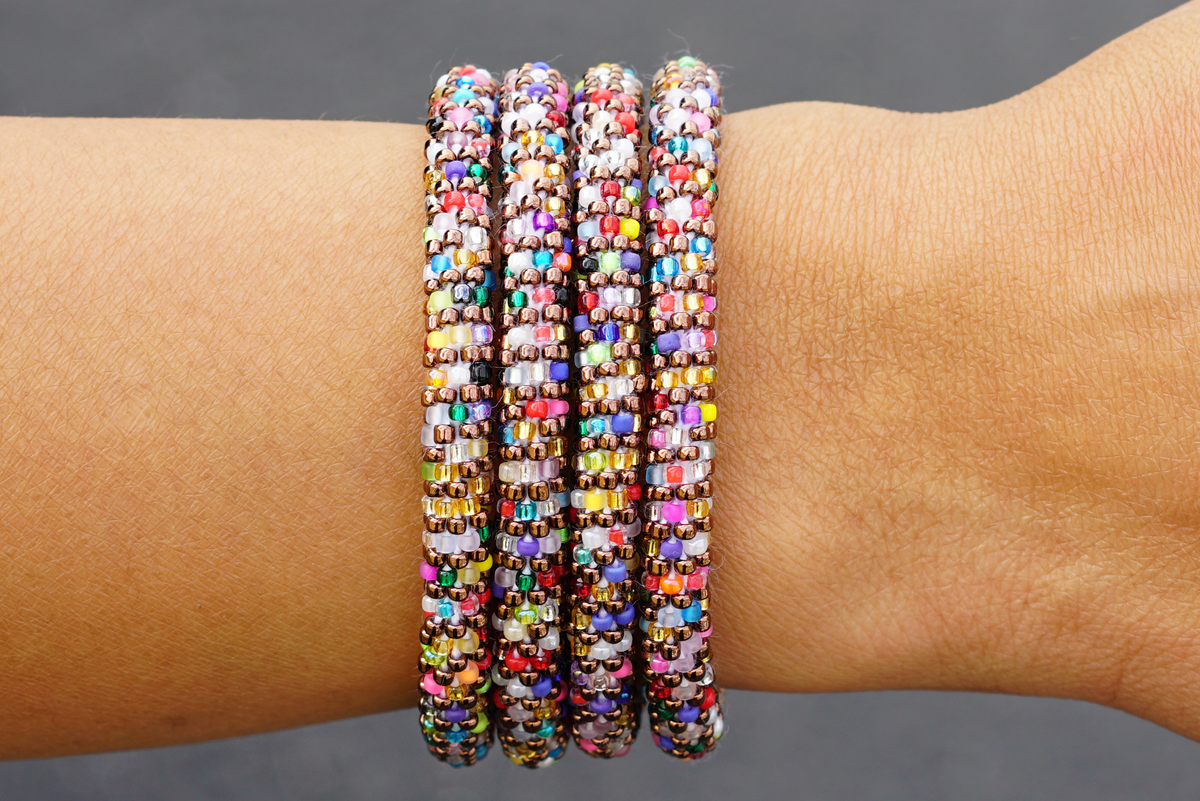 Sashka Co handmade beaded friendship bracelet with iridescent brown glass beads and confetti line accents. Crafted in Nepal by skilled artisans.