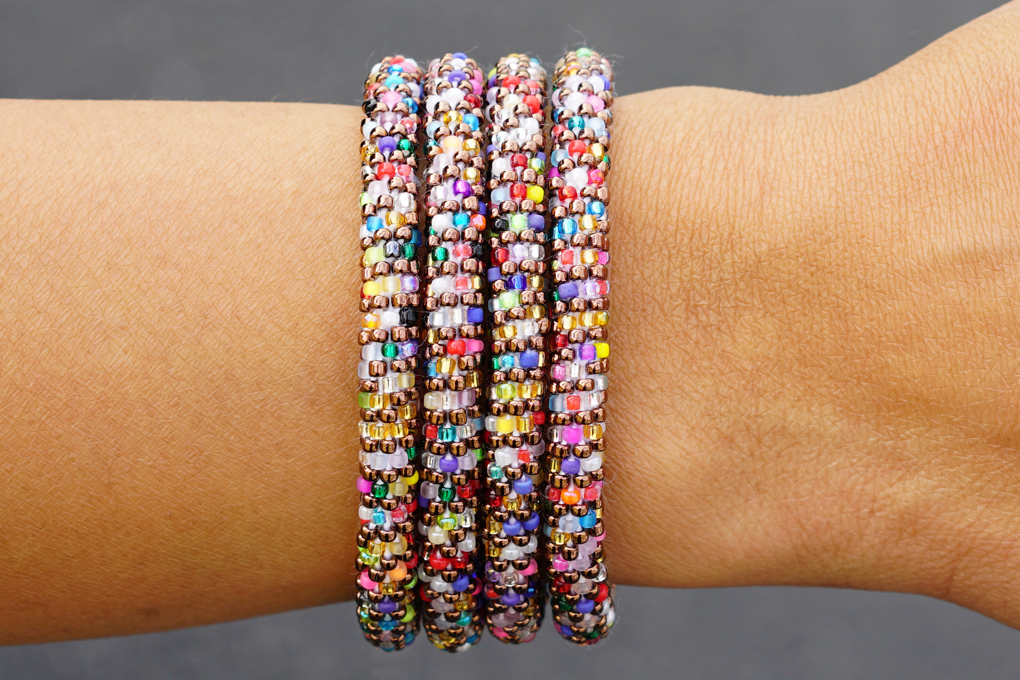 Sashka Co handmade beaded friendship bracelet with iridescent brown glass beads and confetti line accents. Crafted in Nepal by skilled artisans.