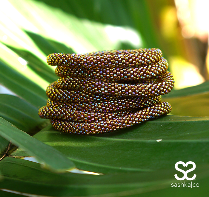 Handmade beaded friendship bracelet with iridescent brown glass beads. Crafted by artisans in Nepal for Sashka Co.