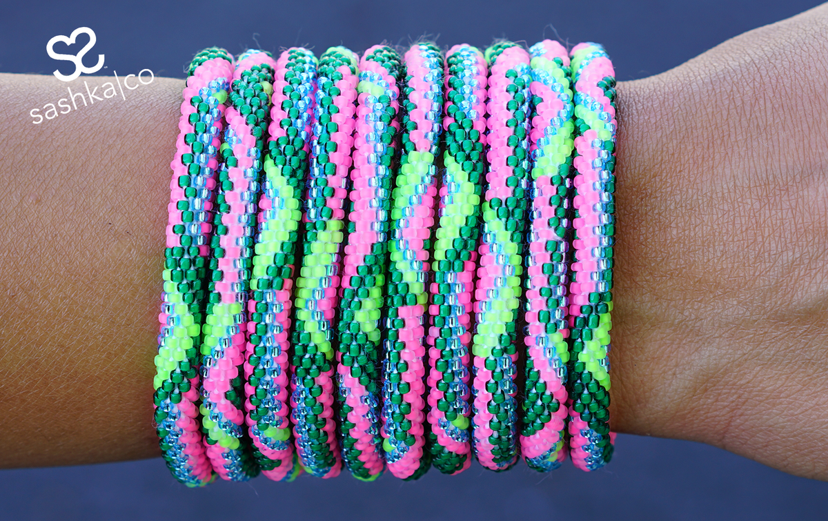 Sashka Co handmade beaded friendship bracelet with matte neon pink, green, matte neon green, and clean blue glass beads. Crafted in Nepal by skilled artisans.
