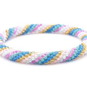 Sashka Co. handmade beaded friendship bracelet with pink, blue, gold, and turquoise glass beads in a spiral pattern. Crafted in Nepal by skilled artisans.