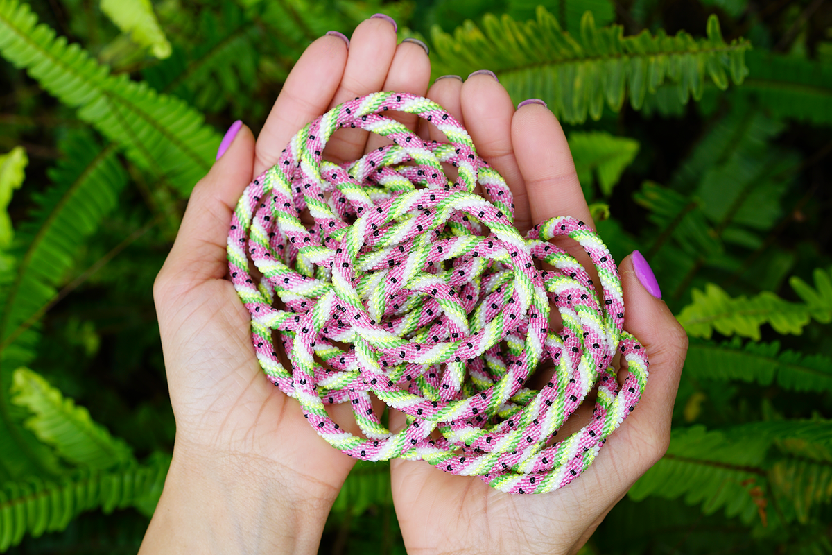 Sashka Co handmade beaded friendship bracelet with pink, green, white, and black glass beads. Crafted in Nepal by skilled artisans.