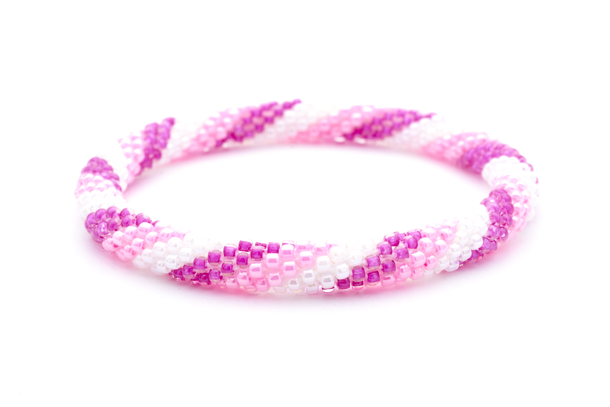 Sashka Co. handmade glass beaded friendship bracelet with pink, light pink, and white glass beads in a spiral pattern. Crafted in Nepal by skilled artisans.
