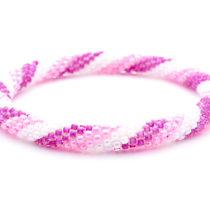 Sashka Co. handmade glass beaded friendship bracelet with pink, light pink, and white glass beads in a spiral pattern. Crafted in Nepal by skilled artisans.