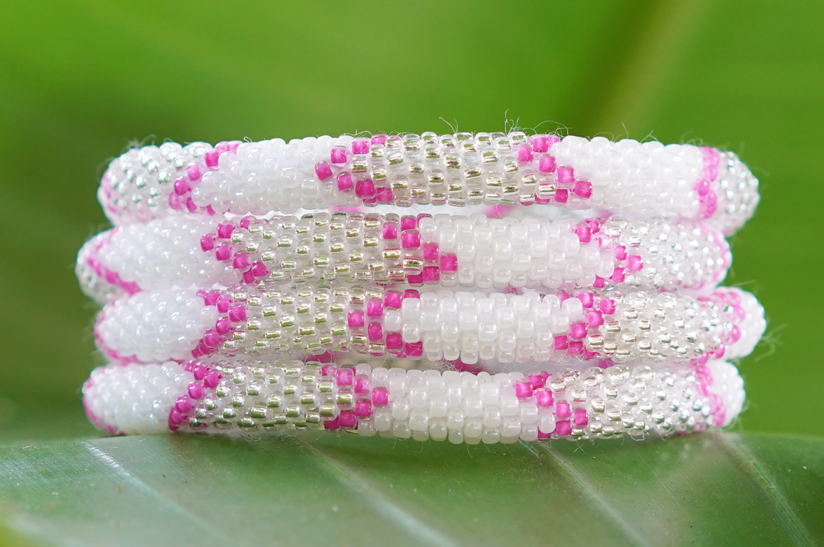 Sashka Co. handmade glass beaded friendship bracelet with pink, white, and clear glass beads in a chevron pattern. Crafted in Nepal by skilled artisans.