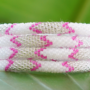 Sashka Co. handmade glass beaded friendship bracelet with pink, white, and clear glass beads in a chevron pattern. Crafted in Nepal by skilled artisans.