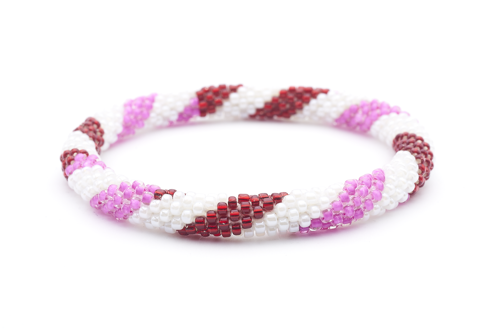 Sashka Co. handmade glass beaded friendship bracelet with red, white, and pink glass beads in a spiral pattern. Crafted in Nepal by skilled artisans.
