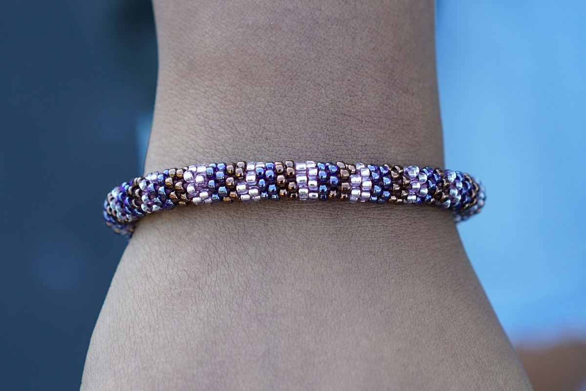 Sashka Co. handmade glass beaded friendship bracelet with silver, rose gold, and brown glass beads in a line pattern. Crafted in Nepal by skilled artisans.