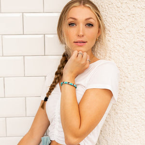 Sashka Co handmade beaded friendship bracelet with turquoise, black, and clear glass beads in a block spiral design. Crafted in Nepal by skilled artisans.