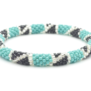 Sashka Co handmade beaded friendship bracelet with turquoise, black, and clear glass beads in a block spiral design. Crafted in Nepal by skilled artisans.