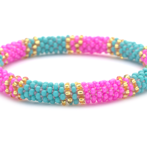 Sashka Co. handmade glass beaded friendship bracelet with turquoise, pink, and gold glass beads. Crafted in Nepal by skilled artisans.