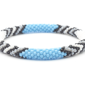 Sashka Co. handmade glass beaded friendship bracelet with white, black, gray, and baby blue beads in a chevron arrow pattern. Crafted in Nepal by skilled artisans.
