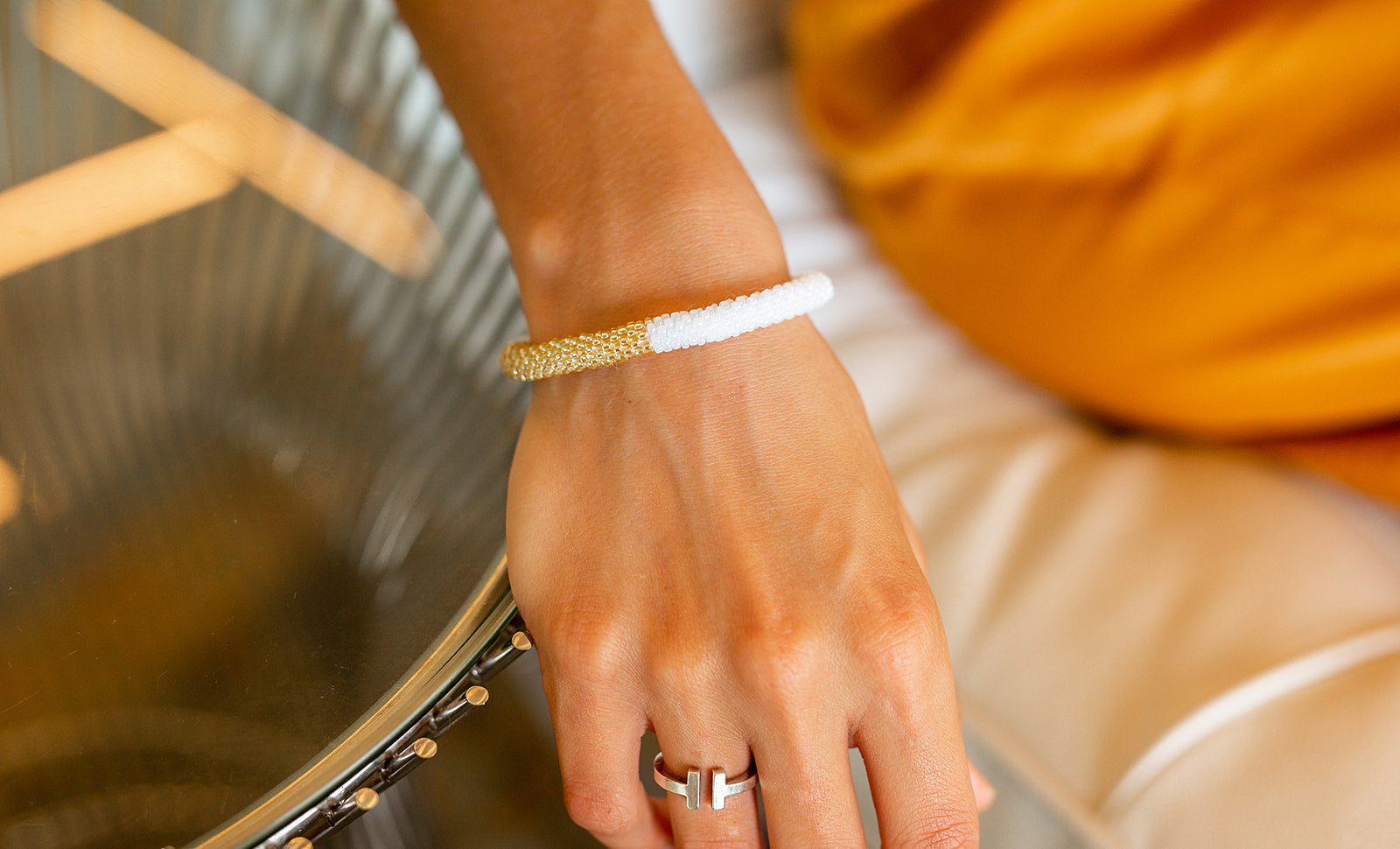 Sashka Co handmade beaded friendship bracelet with white and champagne gold glass beads. Crafted in Nepal by skilled artisans.