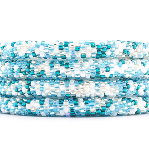 Handmade beaded friendship bracelet with white, clear, light blue, and teal glass beads. Crafted by artisans in Nepal for Sashka Co.