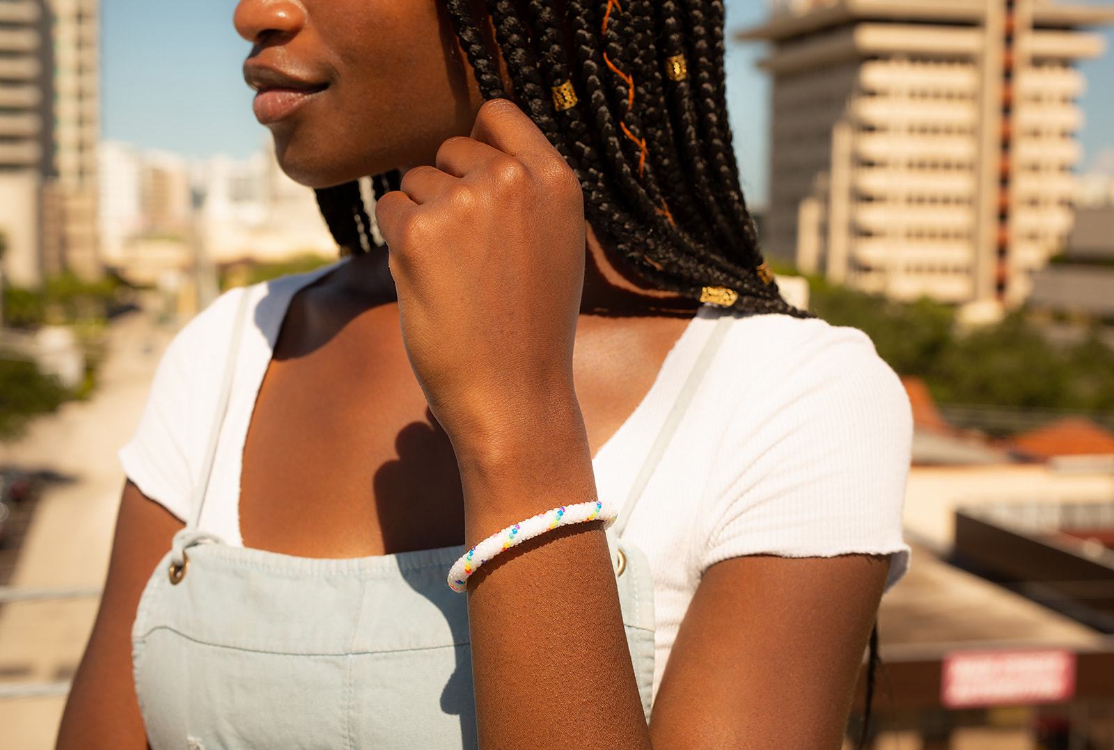 Sashka Co handmade beaded friendship bracelet with white and rainbow spiral glass beads. Crafted in Nepal by skilled artisans.