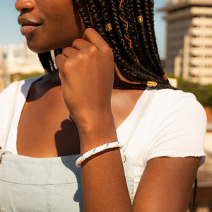 Sashka Co handmade beaded friendship bracelet with white and rainbow spiral glass beads. Crafted in Nepal by skilled artisans.