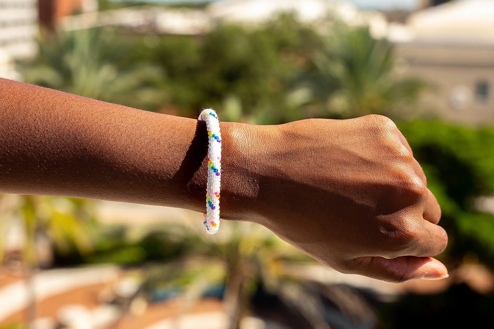 Sashka Co handmade beaded friendship bracelet with white and rainbow spiral glass beads. Crafted in Nepal by skilled artisans.