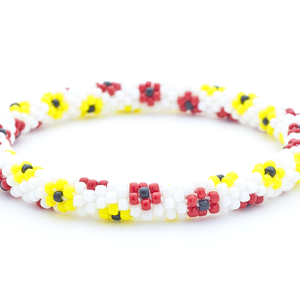 Sashka Co. handmade beaded friendship bracelet with white, red, yellow, and black glass beads in a flower pattern. Crafted in Nepal by skilled artisans.