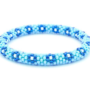 Sashka Co handmade beaded friendship bracelet with baby blue, blue, and white glass beads. Crafted in Nepal by skilled artisans in a flower pattern.
