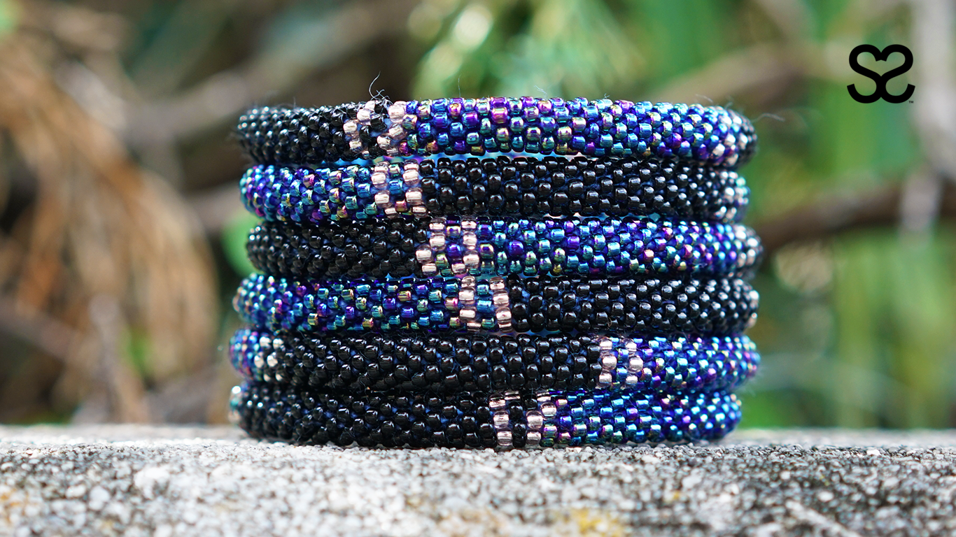 Sashka Co handmade beaded friendship bracelet with black, clear, and iridescent blue glass beads. Crafted in Nepal by skilled artisans.