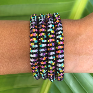 Sashka Co handmade beaded friendship bracelet with black, pink, yellow, aqua, clear, purple, and orange glass beads. Crafted in Nepal by skilled artisans.