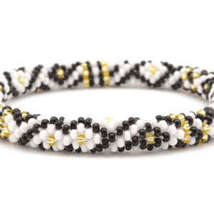 Sashka Co handmade beaded friendship bracelet with black, white, and gold glass beads. Crafted in Nepal by skilled artisans in a diamond pattern.