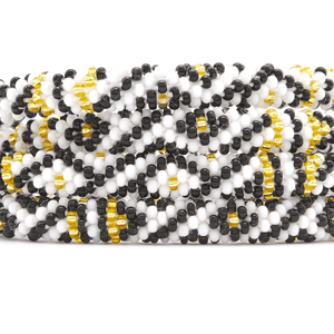 Sashka Co handmade beaded friendship bracelet with black, white, and gold glass beads. Crafted in Nepal by skilled artisans in a diamond pattern.
