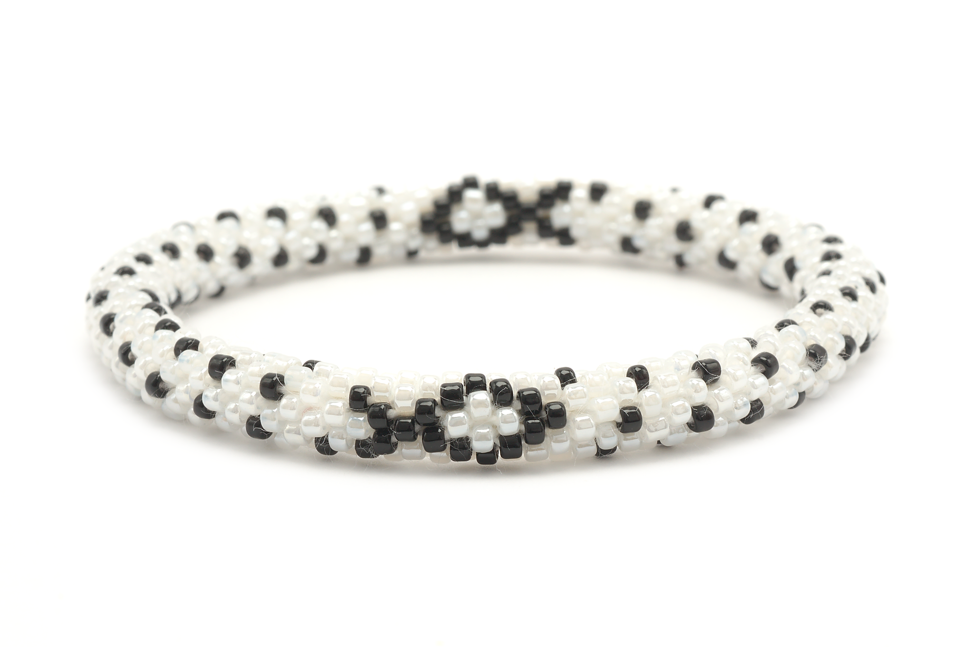 Sashka Co handmade beaded friendship bracelet with black and white glass beads. Crafted in Nepal by skilled artisans in a detailed ribbon pattern.
