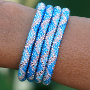 Sashka Co handmade beaded friendship bracelet with blue, light blue, and rose gold glass beads. Crafted in Nepal by skilled artisans.