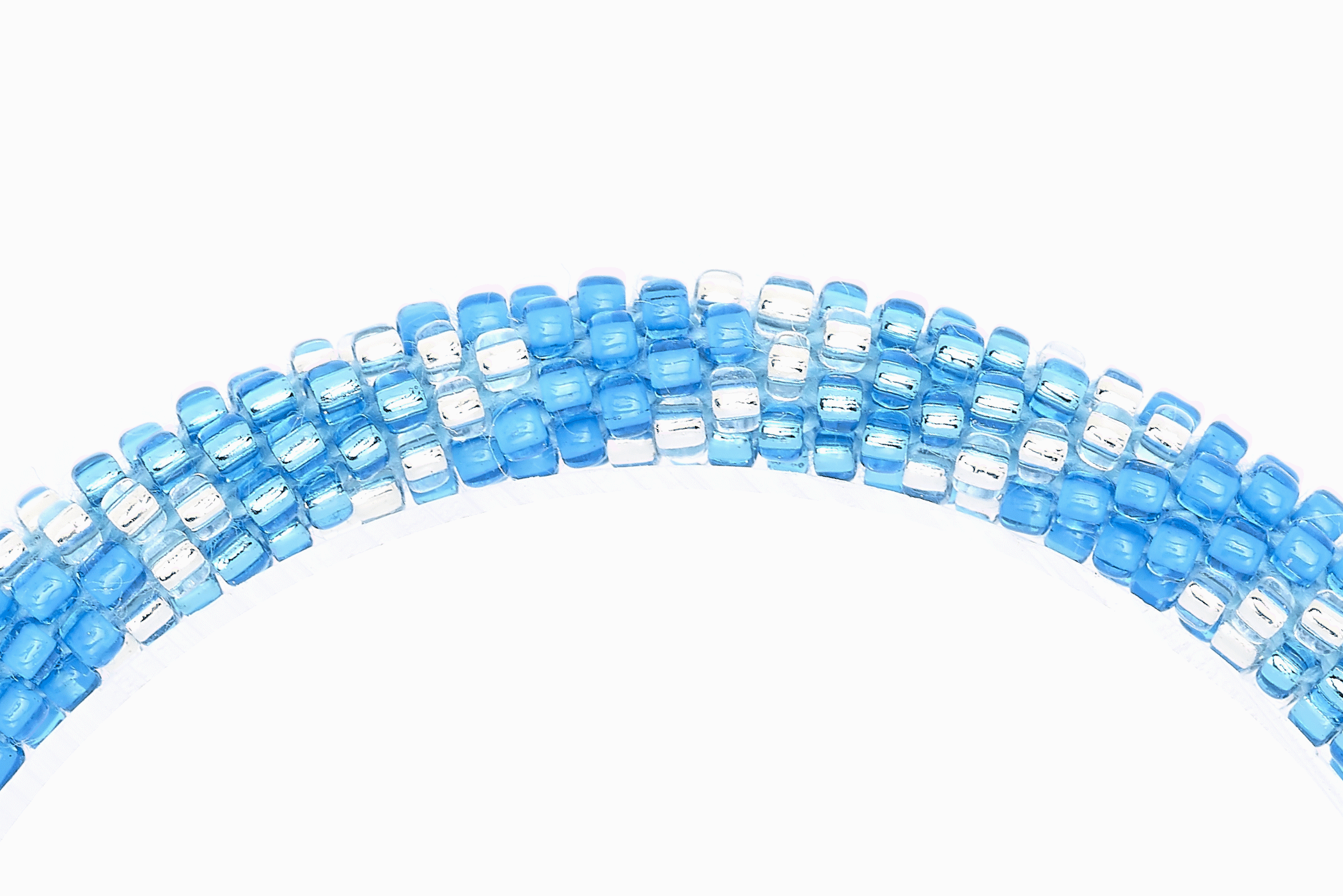 Sashka Co handmade beaded friendship bracelet with blue, metallic blue, and clear glass beads. Crafted in Nepal by skilled artisans in a chevron pattern.