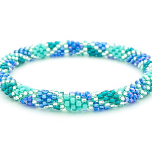 Sashka Co handmade beaded friendship bracelet with blue, teal, turquoise, and clear glass beads. Crafted in Nepal by skilled artisans in a detailed line spiral pattern.