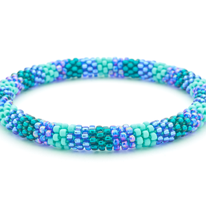 Sashka Co handmade beaded friendship bracelet with blue, turquoise, and teal glass beads. Crafted in Nepal by skilled artisans in a detailed line pattern.
