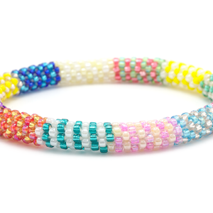 Sashka Co handmade beaded friendship bracelet with blue, yellow, rose gold, purple, white, gold, orange, teal, pink, green, and red glass beads. Crafted in Nepal by skilled artisans.