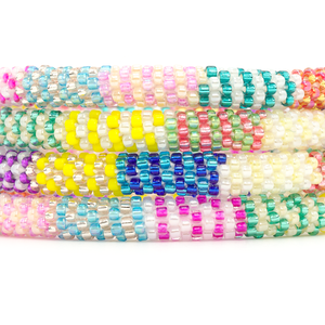 Sashka Co handmade beaded friendship bracelet with blue, yellow, rose gold, purple, white, gold, orange, teal, pink, green, and red glass beads. Crafted in Nepal by skilled artisans.