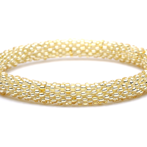 Sashka Co handmade beaded friendship bracelet in solid champagne gold. Artisan crafted in Nepal.

