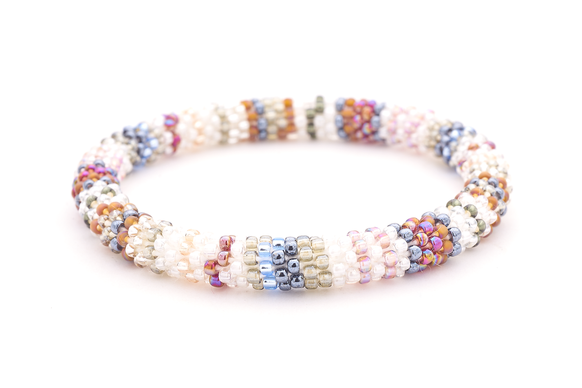 Sashka Co handmade beaded friendship bracelet with clear, silver, mauve, white, blue, red, and pink line pattern. Crafted in Nepal by skilled artisans.