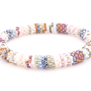 Sashka Co handmade beaded friendship bracelet with clear, silver, mauve, white, blue, red, and pink line pattern. Crafted in Nepal by skilled artisans.