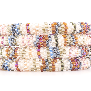 Sashka Co handmade beaded friendship bracelet with clear, silver, mauve, white, blue, red, and pink line pattern. Crafted in Nepal by skilled artisans.
