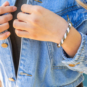Sashka Co handmade beaded friendship bracelet with gold, white, and black glass beads. Crafted in Nepal by skilled artisans.