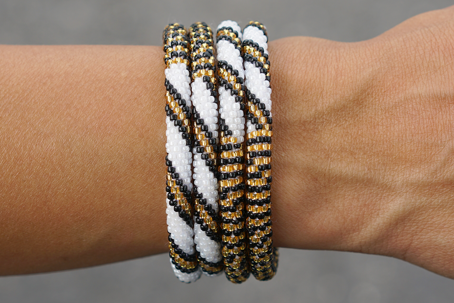 Sashka Co handmade beaded friendship bracelet with gold, white, and black glass beads. Crafted in Nepal by skilled artisans.