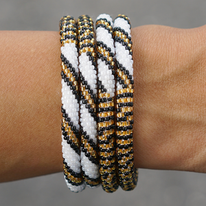 Sashka Co handmade beaded friendship bracelet with gold, white, and black glass beads. Crafted in Nepal by skilled artisans.