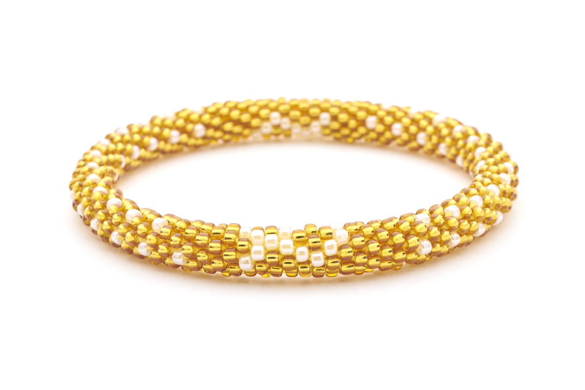 Sashka Co handmade beaded friendship bracelet with gold and white glass beads. Crafted in Nepal by skilled artisans in a cancer ribbon pattern.