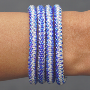 Sashka Co handmade beaded friendship bracelet with iridescent blue and clear glass beads. Crafted in Nepal by skilled artisans in a zipper pattern.
