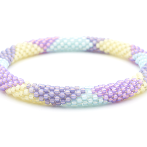 Sashka Co handmade beaded friendship bracelet with light purple, mint, purple, and pale yellow glass beads. Crafted in Nepal by skilled artisans in a large diamond pattern.