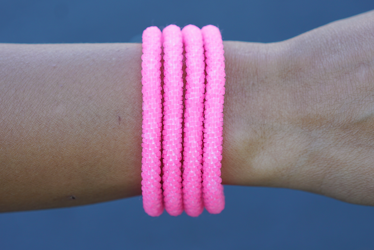 Sashka Co handmade beaded friendship bracelet with matte neon pink glass beads. Crafted in Nepal by skilled artisans in a solid pattern.