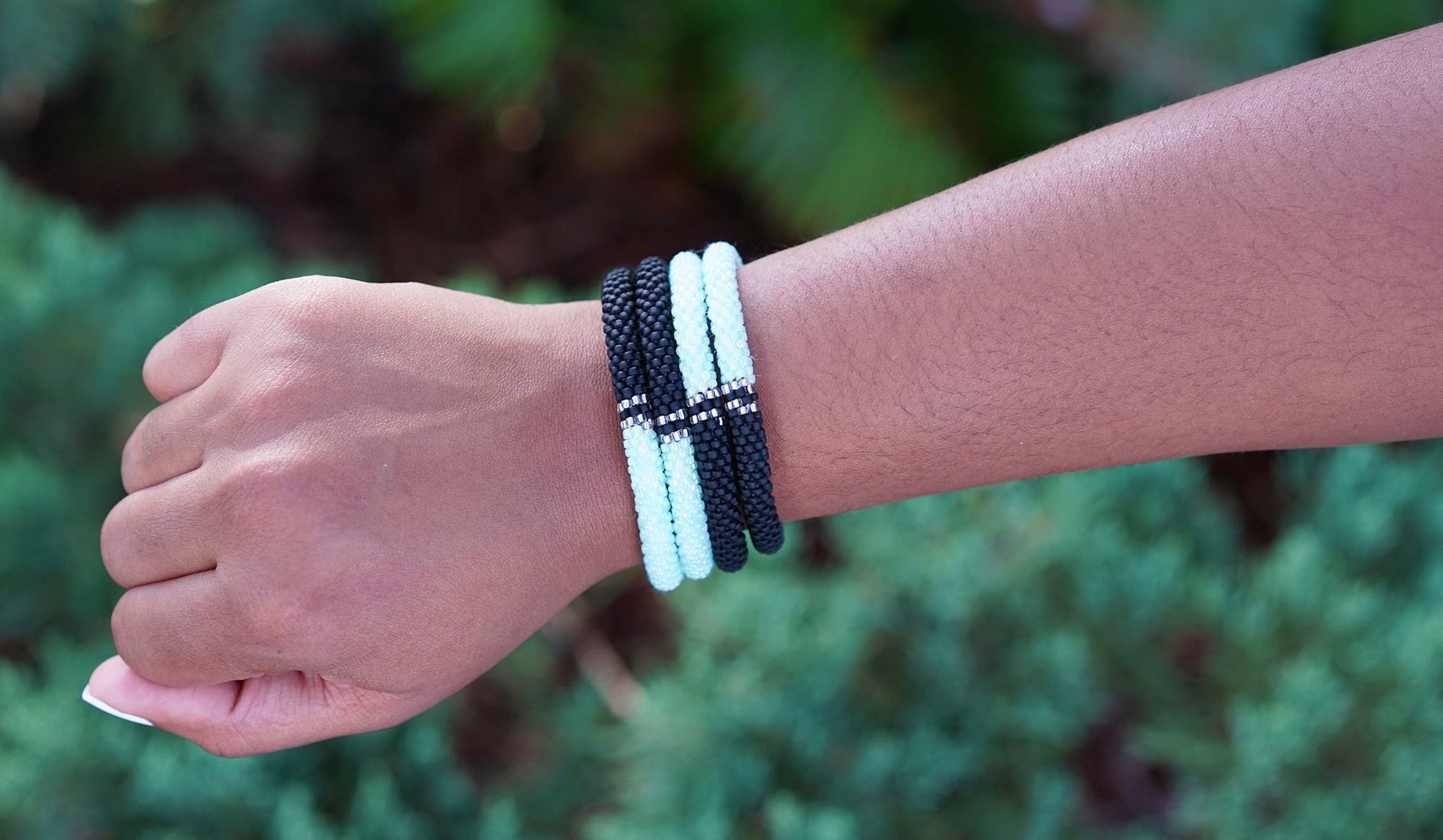 Sashka Co handmade beaded friendship bracelet in a half-and-half pattern with mint, clear, and matte black. Artisan-crafted in Nepal.
