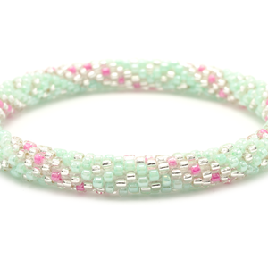 Sashka Co handmade beaded friendship bracelet with mint, clear, and pink glass beads. Crafted in Nepal by skilled artisans in a spiral pattern.