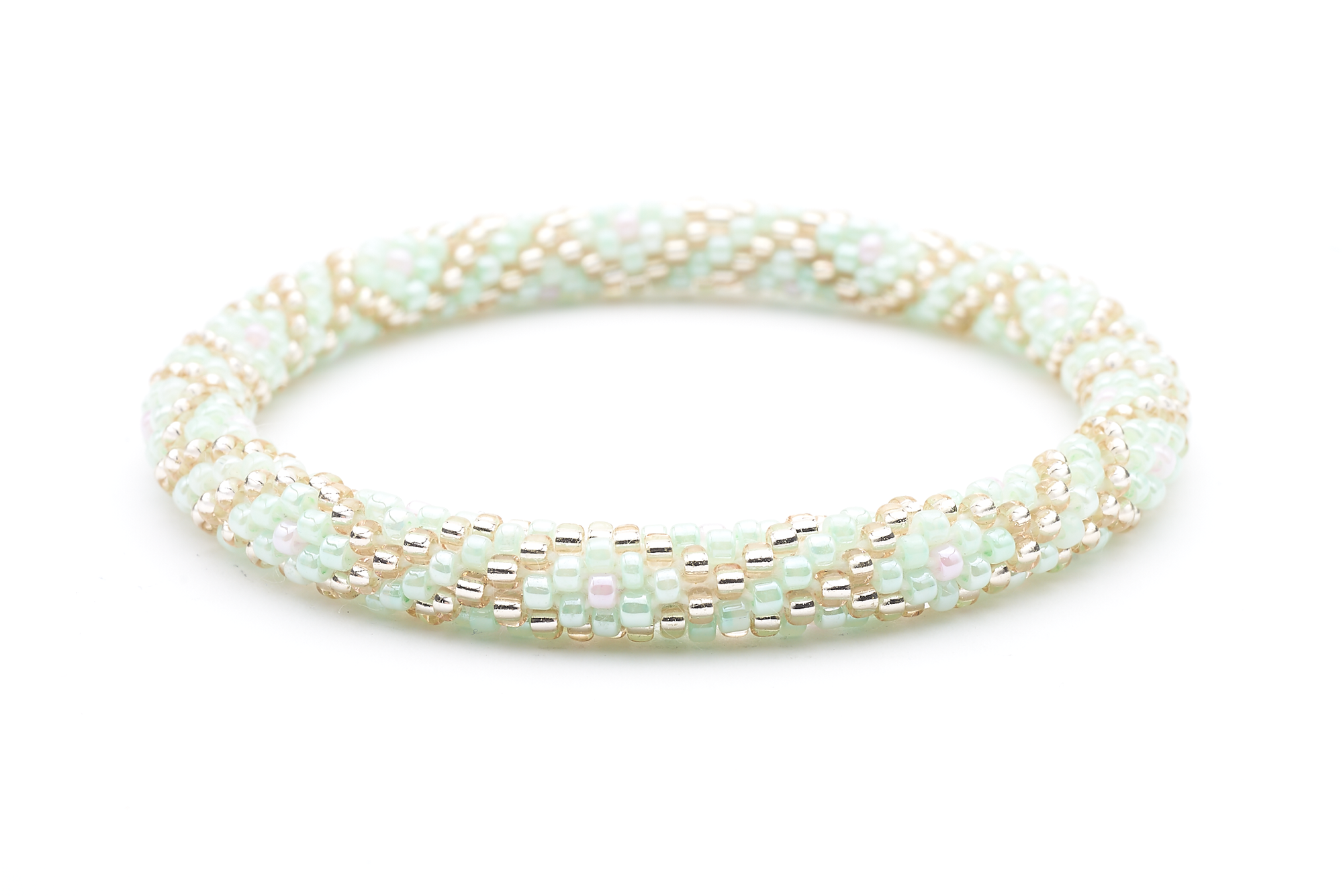 Sashka Co handmade beaded friendship bracelet with mint, rose gold, and pink criss cross pattern. Crafted in Nepal by skilled artisans.